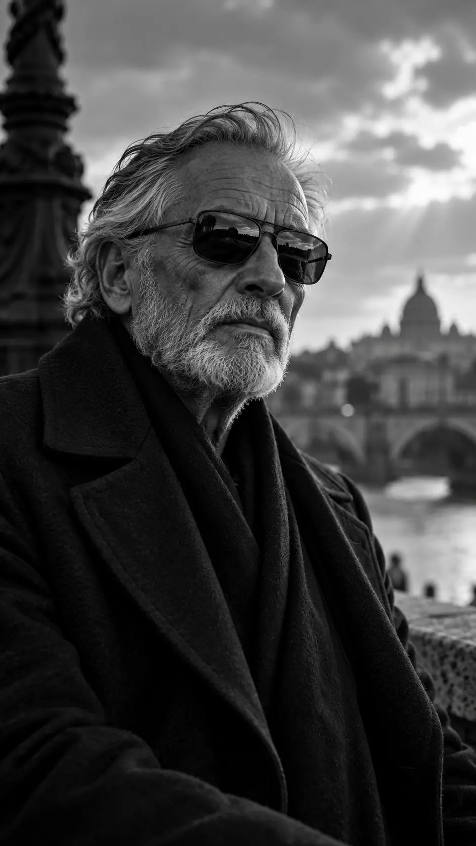 Black and white close-up portrait of an elderly man wearing sunglasses, a dark coat, and scarf, with a historic city and river background.